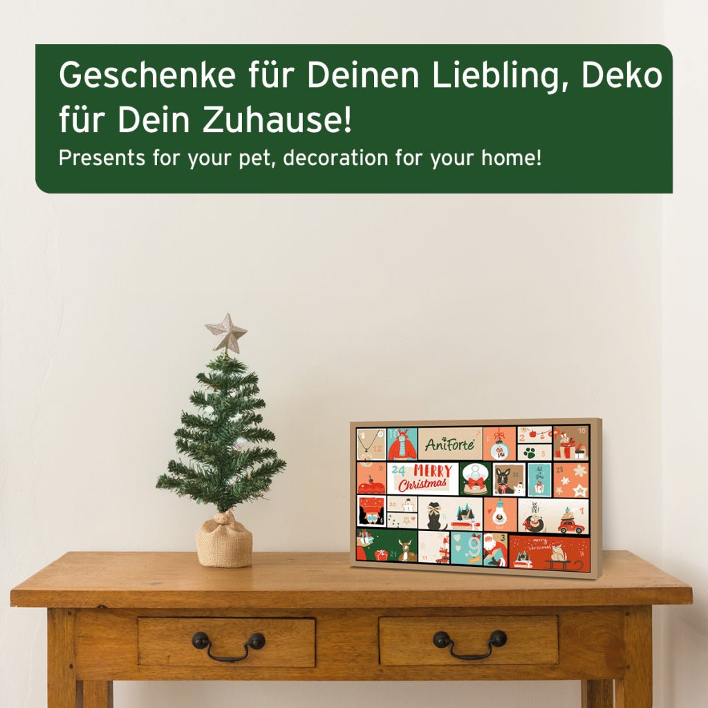 AniForte Premium Adventskalender für Hunde mit natürlichen Snacks und Pflegeprodukten in festlicher Verpackung auf Holztisch neben Weihnachtsbaum