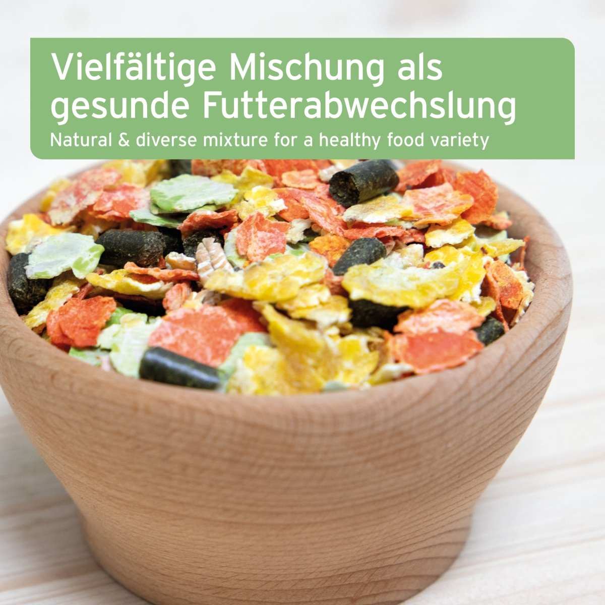 Vielseitiges Natur Nagerfutter in einer Holzschale, gesunde Mischung aus Gemüseflocken und Getreide.